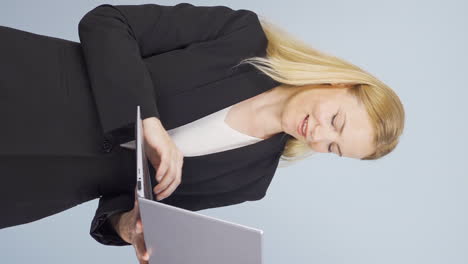 Vertical-video-of-Business-woman-relaxes-after-finishing-her-work-on-laptop.